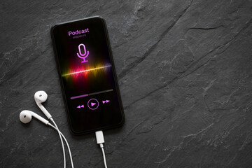 Earphones and mobile phone with podcast app on screen - obrazy, fototapety, plakaty
