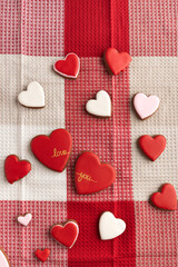 Heart shaped cookies on checkered textile tablecloth. Vertical frame