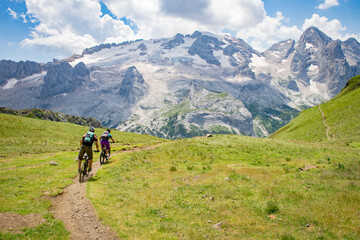 Man and woman mountain biking in the Dolomites, Val Gardena, South Tyrol, Italy