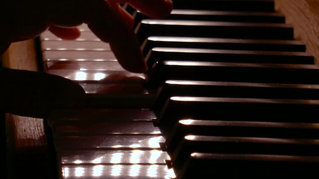 Piano playing with backlight closeup