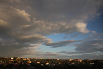Evening rainbow sky after a thunderstorm. Small town and heavenly theater