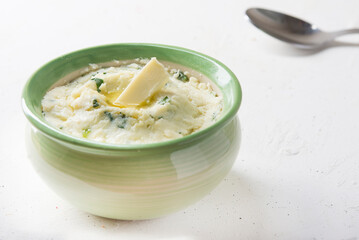 Mashed potatoes in green bowl close up