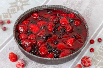 summer round berry pie, a cake decorated with strawberries and black currants in jelly, healthy vegan dessert