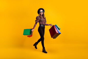 Full length body size side profile photo of girl going from mall with stores keeping packages sale...