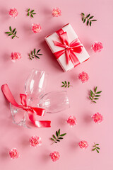 Valentines Day pattern of pink gift box and flowers. Overhead view
