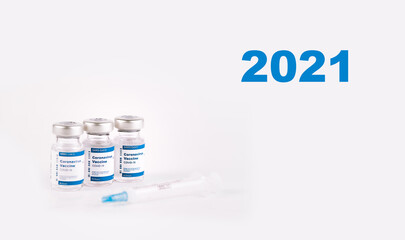 2021 9 vaccine vials and syringe with white background