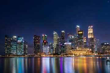 Wide panorama of Singapore cityscape at magic hour.
