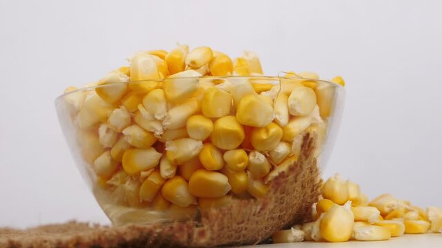 Close micro shot of glass bowl filled with corn seeds