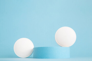 Cosmetics, beauty products background. Cylinder and white circles on blue. Podium stand, trendy minimal geometric scene