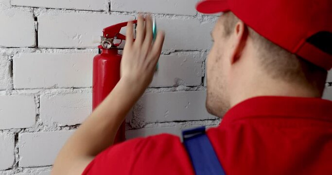 fire safety and prevention - service engineer checking extinguisher condition and writing documents