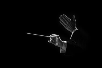 Hands of a conductor of a symphony orchestra close-up in black and white