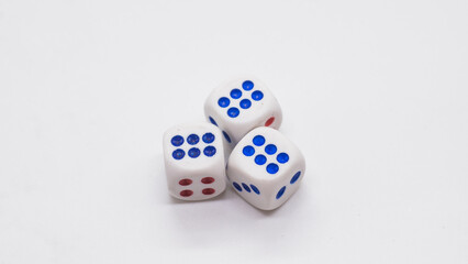 Heap of white cubic tree six dices with blue and red spikes (dots) on a white background. Game, gambling, chance and risk concept