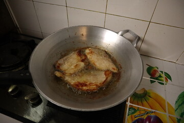 Fried pork in a pan with boiling oil Hot in the kitchen