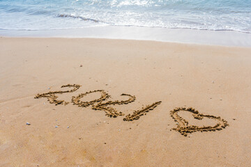 2021 year and love heart sign hand written sandy beach outdoors seascape background.