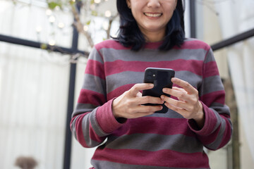 using cell phone hand holding mobile texting message contact us.chatting,search internet...