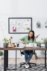 young african american architect making models of buildings while working at home studio