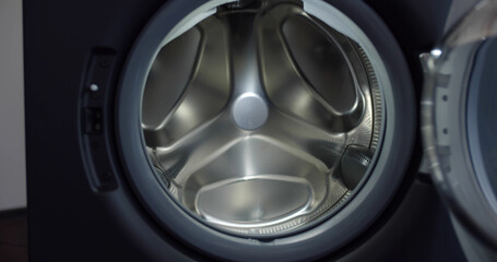 Close up of modern open empty washing machine