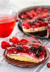 a piece of berry pie closeup, a cake decorated with strawberries and black currants in jelly, healthy nutrition, vegan dessert