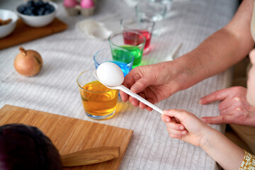 Close up of dyeing Easter eggs