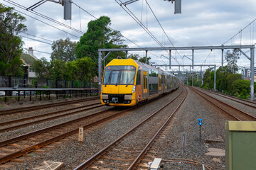 Commuter Train fast moving through a Station in Sydney NSW Australia