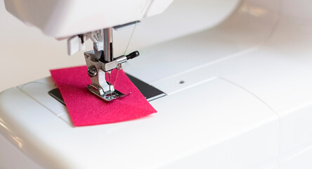 sewing machine with pink fabric in working, equipment for sewing