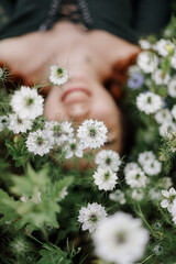 Obraz na płótnie Canvas girl on a field of white flowers