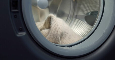 Close up of wool sweater in modern washing machine
