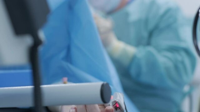 Operation of removing tonsils. tonsillectomy under deep anesthesia, using latest devices, cold plasma method, cuts swelling in throat, doctor works with new probe, medical headlamp, surgical loupes