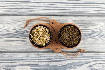 Green beans, sprouted mung bean on light wooden background. Top view, copy space