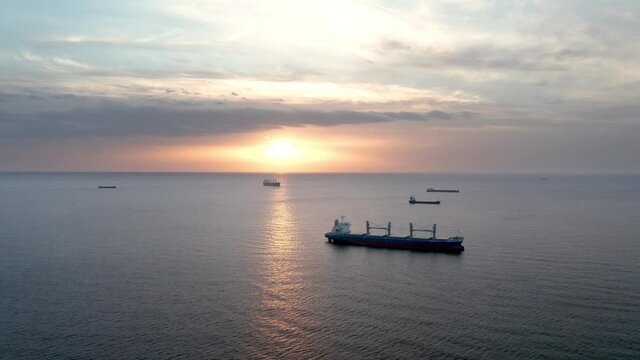 A drone flight around container ships into the sea at sunrise, the Black Sea, Bulgaria
