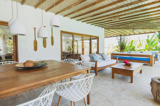 Modern summer holiday or vacation wooden beach house interior with rustic luxury sofas, tables and decoration. 