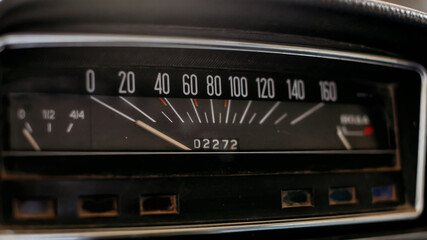 Old retro classic car speedometer close up.