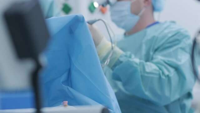 Operation of removing tonsils. tonsillectomy under deep anesthesia, using latest devices, cold plasma method, cuts swelling in throat, doctor works with new probe, medical headlamp, surgical loupes