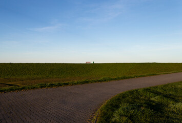 Park bench on a dike