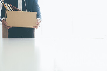 Sad dismissed businessman sitting outside the office after losing his job