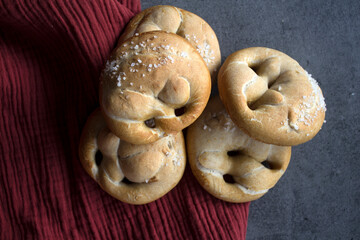 Fresh baked sourdough buns on a kitchen table. Close up photo of homemade bread. Healthy eating concept. 