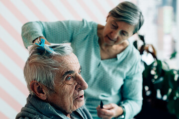 elderly lifestyle. two old people at home. Haircut in a barbershop or hospice.