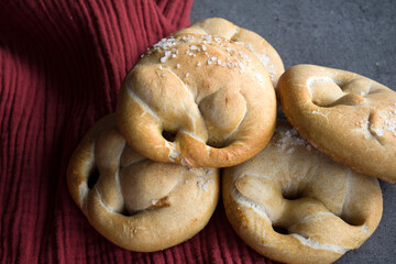 Fresh baked sourdough buns on a kitchen table. Close up photo of homemade bread. Healthy eating concept. 