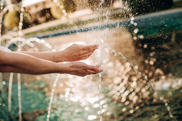 Fototapeta premium hands lovers splashing fountain playing water summer