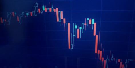 Closeup financial chart in stock market on monitor background. Chart graph as investment concept. Crisis background, red