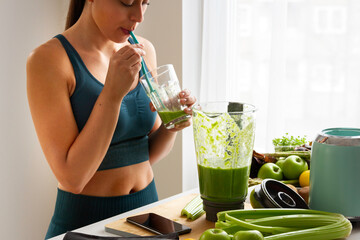 Woman drinking a green smoothie