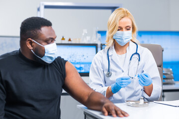 Professional doctor makes a coronavirus vaccine using a syringe and hypodermic needle. Professional...