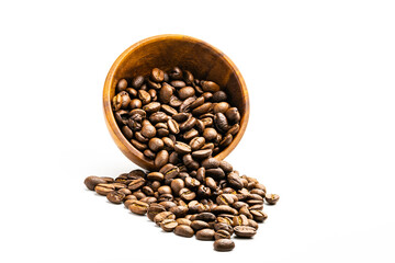 Pile of coffee beans in wooden bowl on white background.