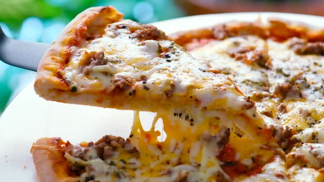Close up view person taking Carbonara pizza slice