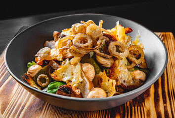 salad with chicken, cucumber, mushrooms, onion and cheese in bowl
