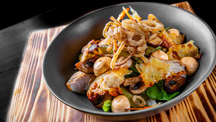 salad with chicken, cucumber, mushrooms, onion and cheese in bowl