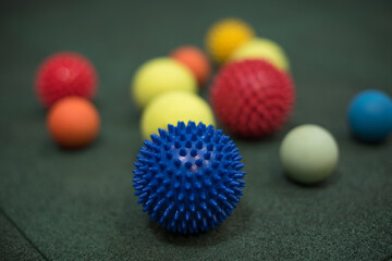 self massage and reflexology therapy concept - a set of small rubber balls and roller bar