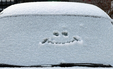 Smiley on the windshield of the car. Close-up.