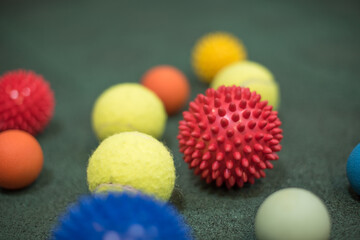 self massage and reflexology therapy concept - a set of small rubber balls and roller bar