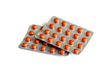 Shiny brown round-shaped tablets in two blister packs